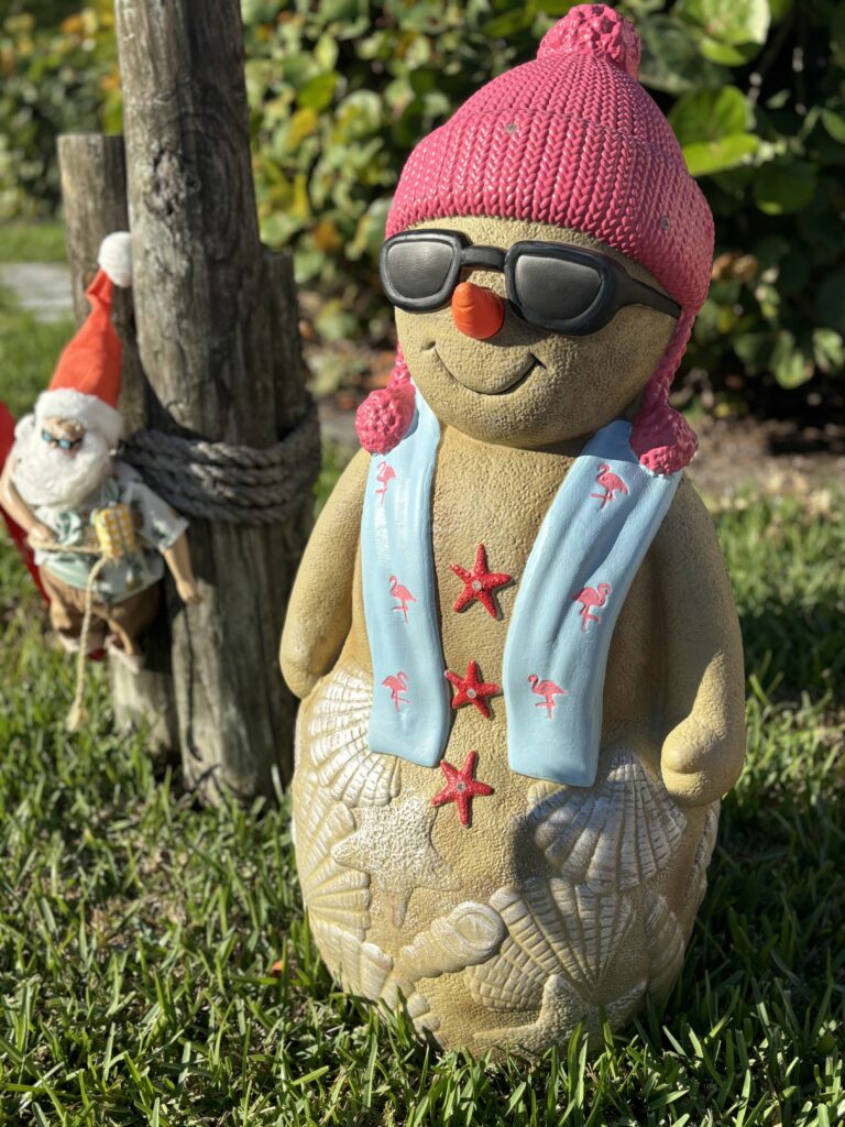 A jolly snowman made from sand and shells donning sunglasses is a common sight during the holiday season in the Florida Keys.